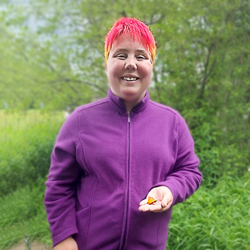 woman with bright hair holding butterfly