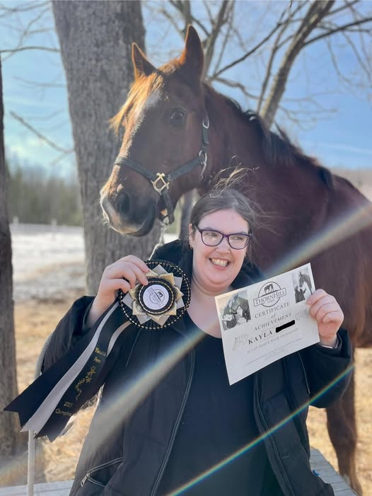 KP holds up her award infront of her favourite horse, Royal.