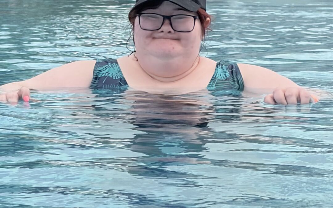 SL lounging and cooling off in the resort pool.