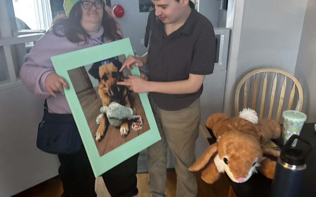SL presents JSO with a gem painting that she made for his Birthday of Piper the Dog.